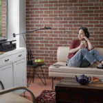 C 368 C 556 Red Brick Room with Female Model and headphones